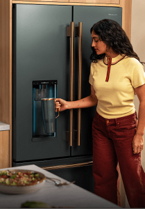 Radhi Devlukia filling a Corkcicle bottle with The MindFULLness Fridge