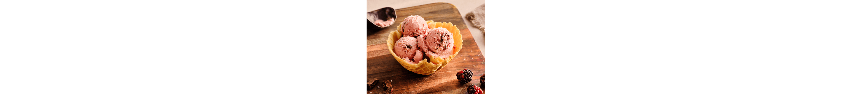 Three scoops of ice cream in a waffle cone bowl