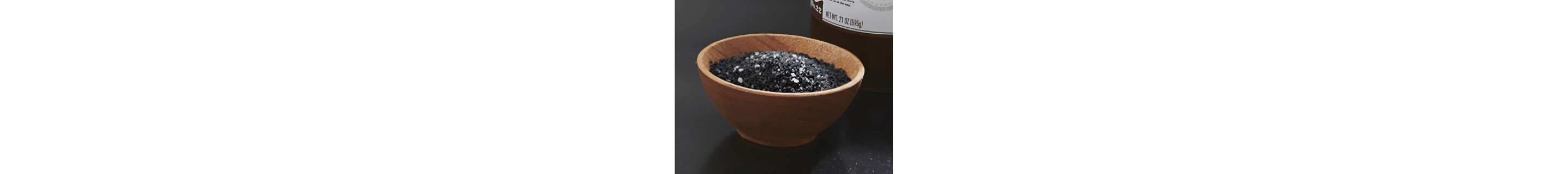 Wooden bowl filled with black salt