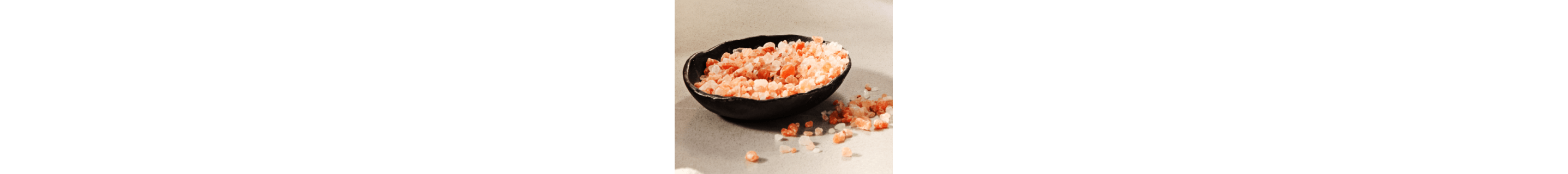 Black bowl filled with pink salt