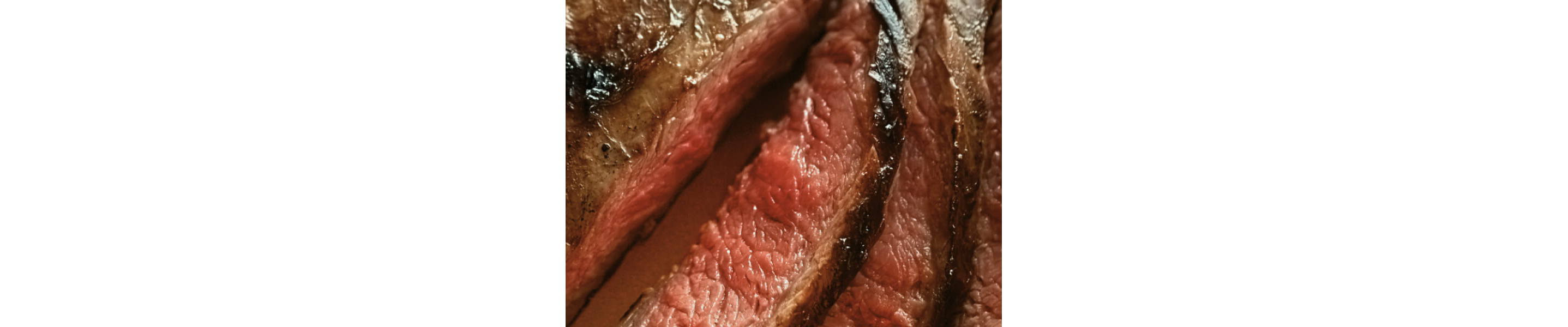 Up close image of a sliced, medium steak