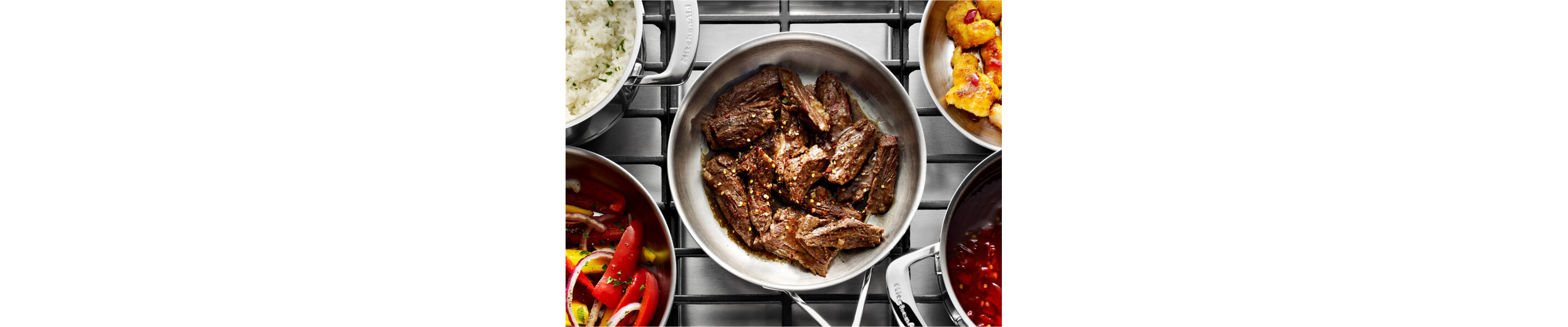 Sliced hanger steak cooking in a stainless steel pan