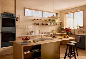 A modern kitchen with a KitchenAid® wall oven, dishwasher and downdraft cooktop