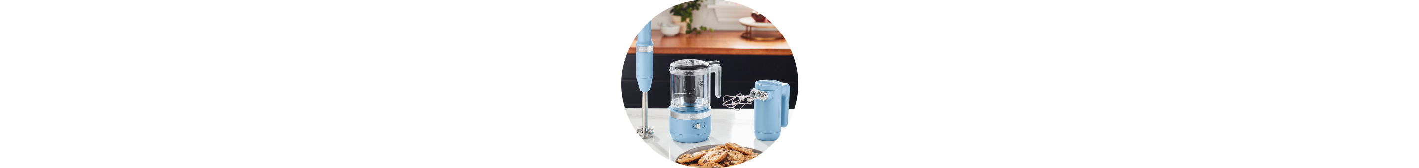 Blue Velvet KitchenAid® Cordless Immersion Blender, Food Chopper, and Hand Mixer on white countertop.