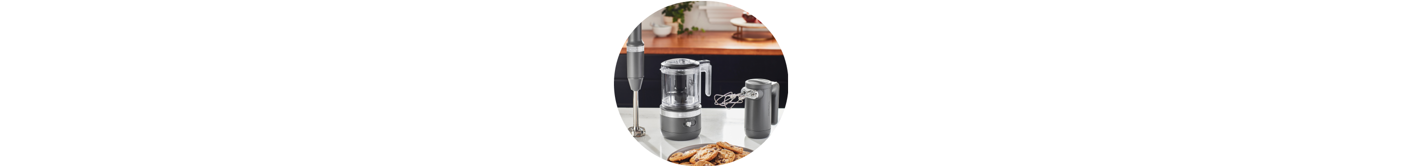 Matte Charcoal Grey KitchenAid® Cordless Immersion Blender, Food Chopper, and Hand Mixer on white countertop.