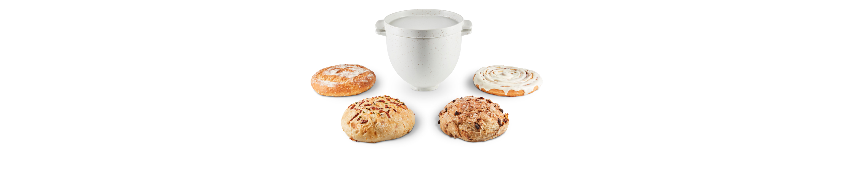 KitchenAid® bread bowl with baking lid surrounded by a variety of bread