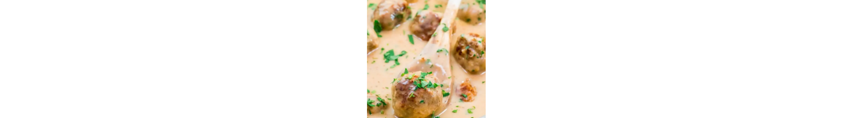 Swedish meatball on wooden spoon
