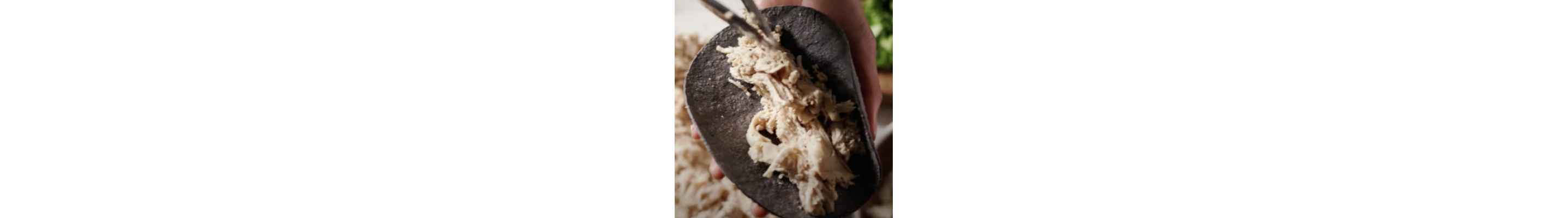 Shredded chicken on a tortilla