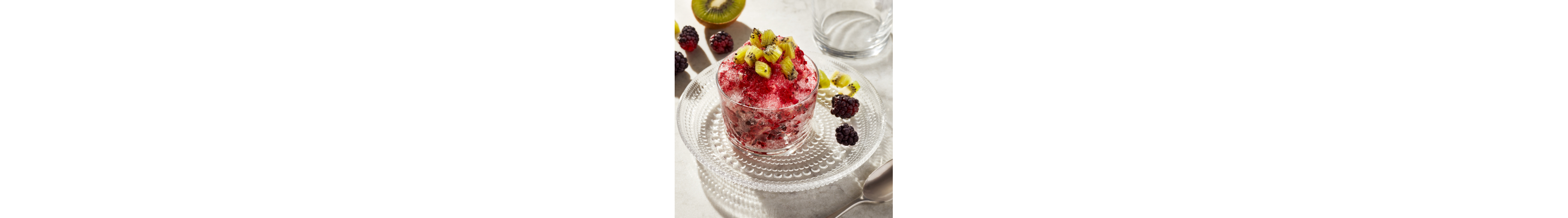A cup of cherry shaved ice with watermelon slices