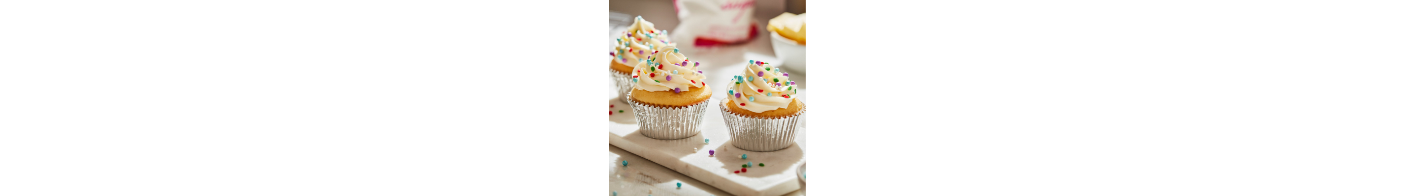 Cupcakes frosted with buttercream frosting and decorative sprinkles