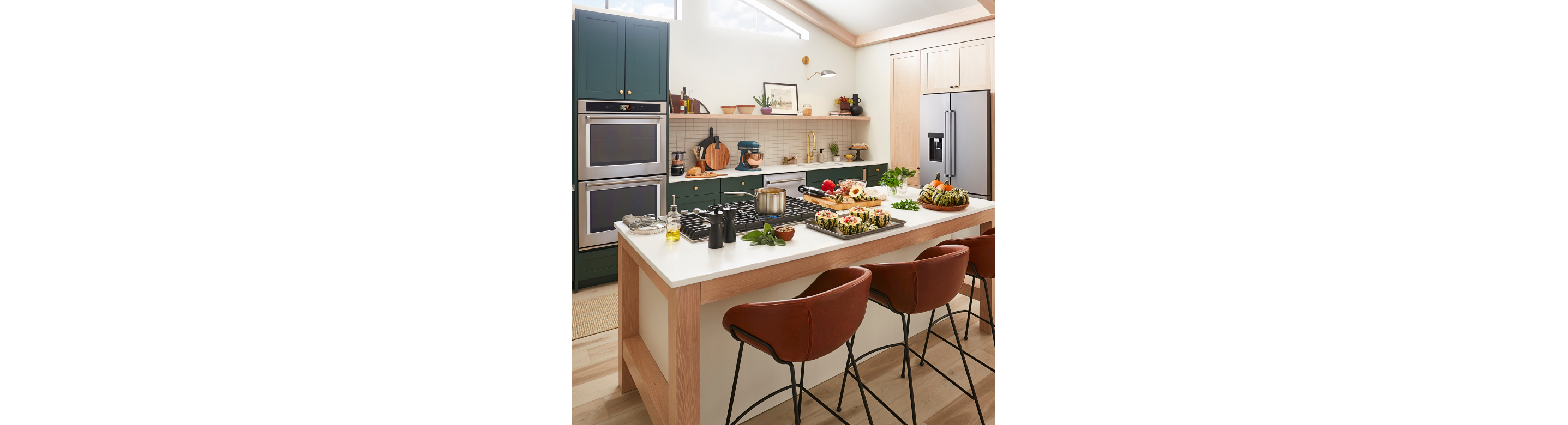 Kitchen island with cooktop and squash dish getting prepped for serving