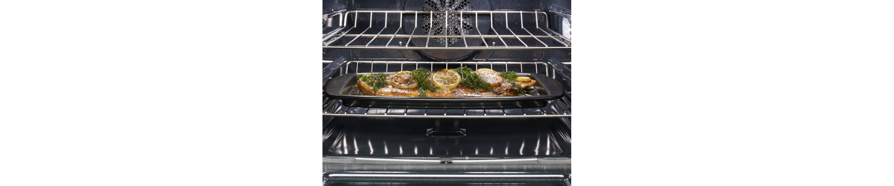 Fish with garnishes in a pan in the oven