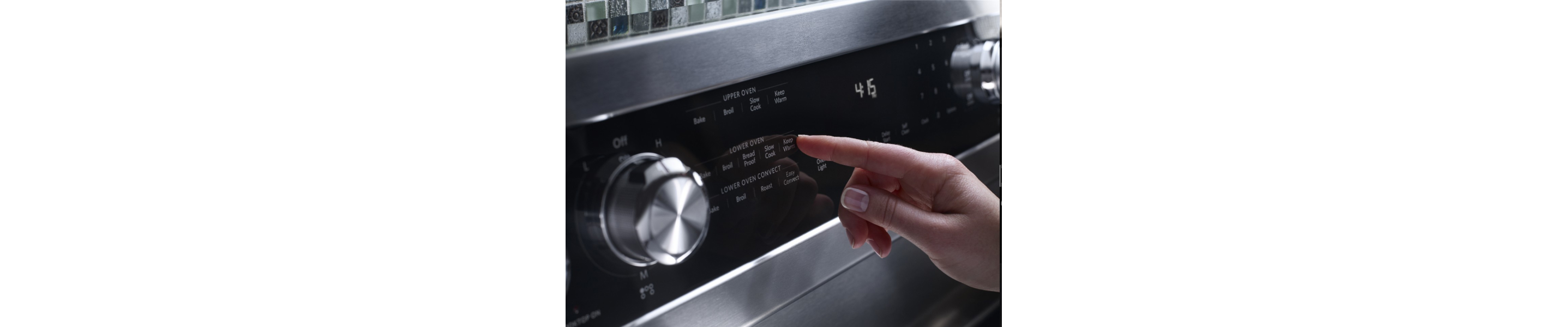 Close-up of a person selecting settings on an oven