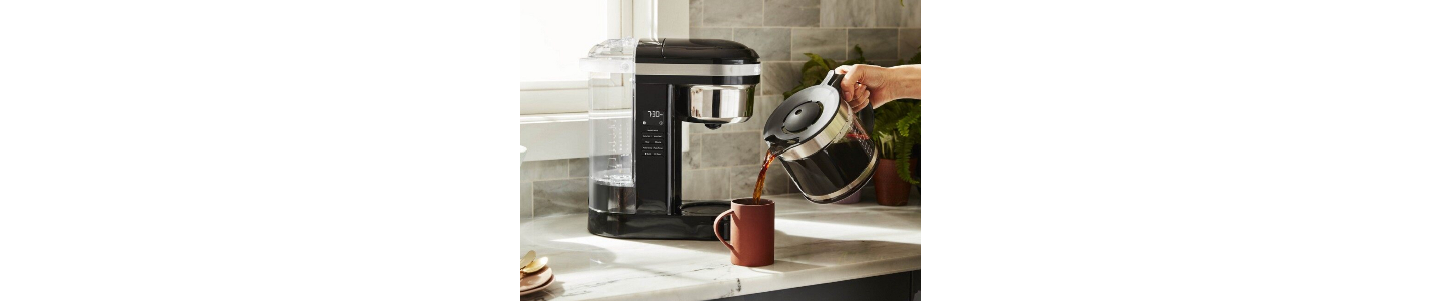 Person pouring from KitchenAid® drip coffee maker