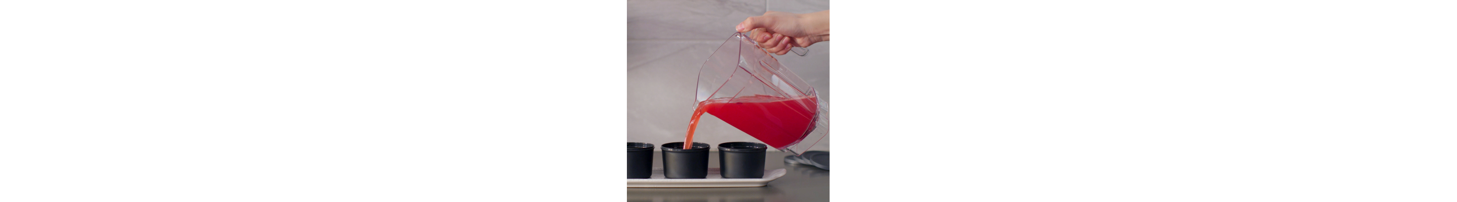 Pitcher of frozen mixture being poured into ice mold