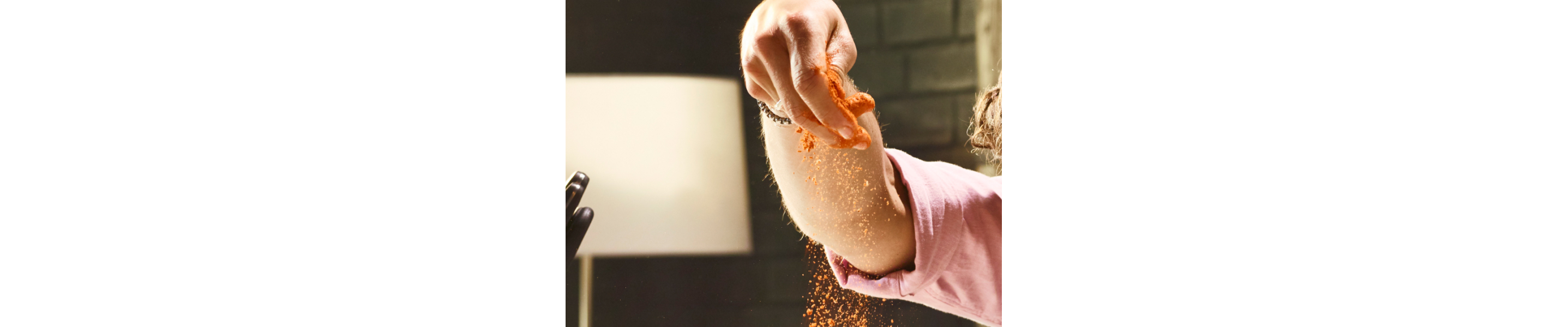 A person sprinkling seasoning
