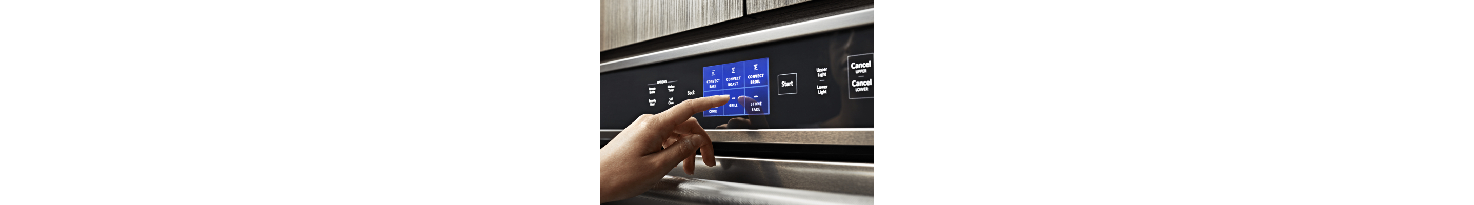 Hand selecting a setting on a KitchenAid® oven control panel