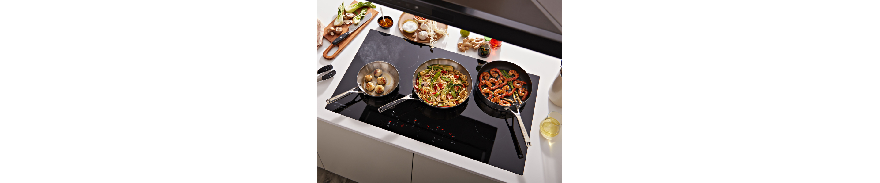 Three dishes cooking on three different burners