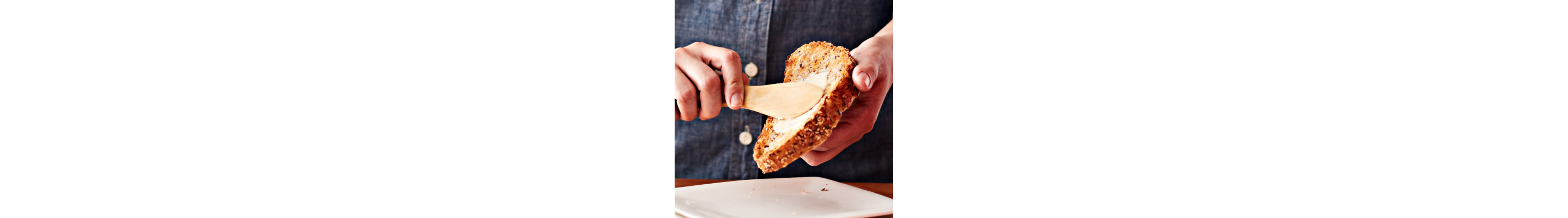 Toast being spread with margarine