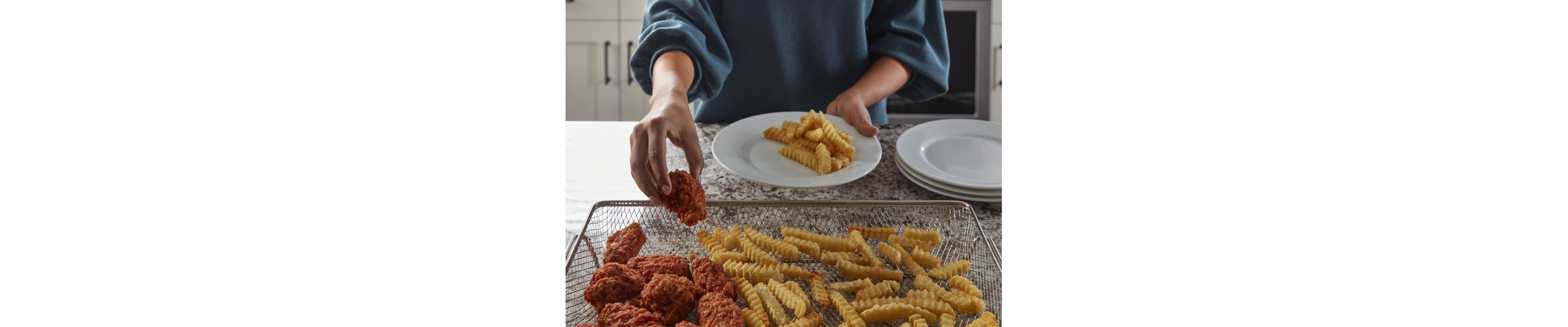  Person removing food from an air fry basket
