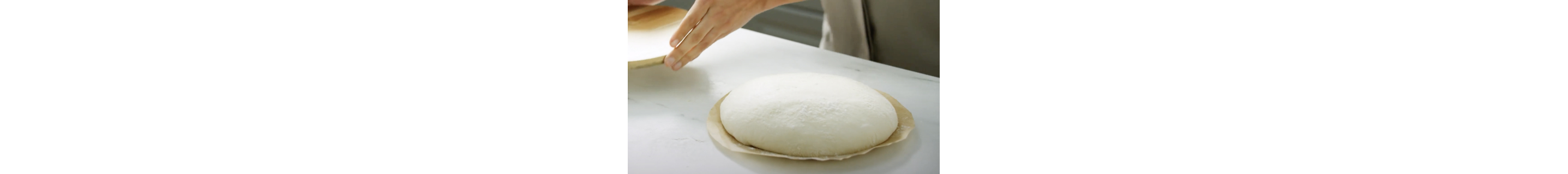A mound of dough resting on parchment paper.