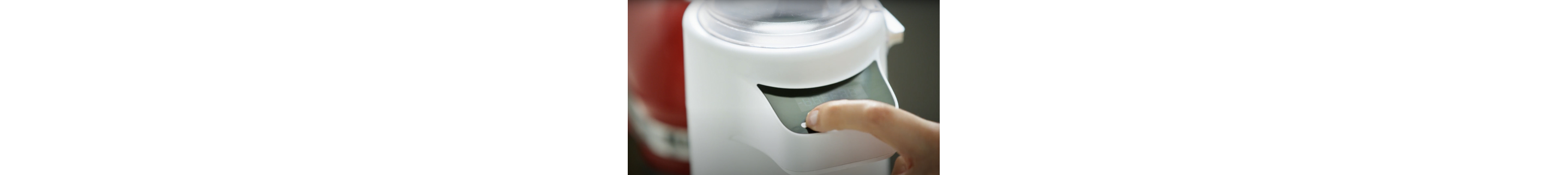 A person using the Sifter+Scale Attachment from KitchenAid brand.