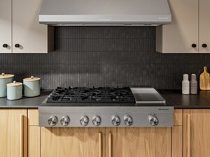 KitchenAid® Gas Rangetop in front of black backsplash 