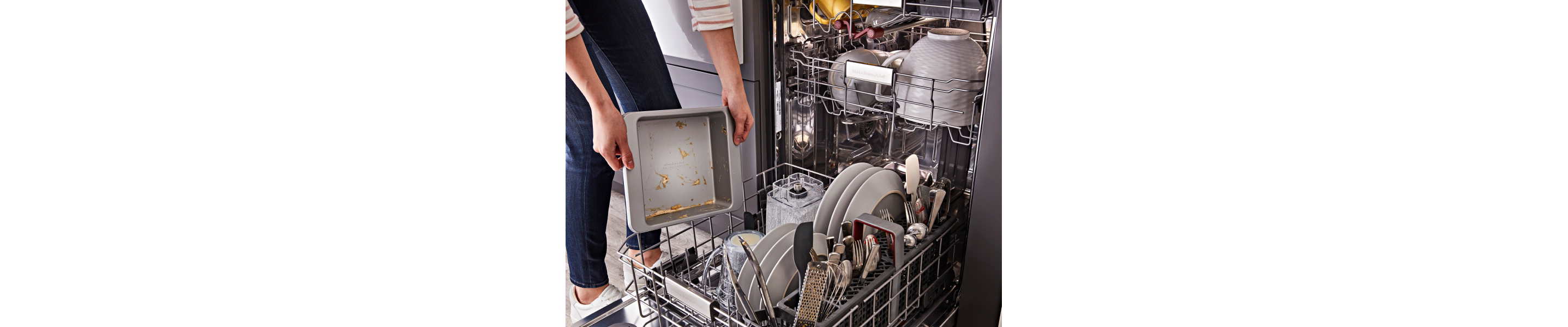 Person loading dirty dishes into a dishwasher