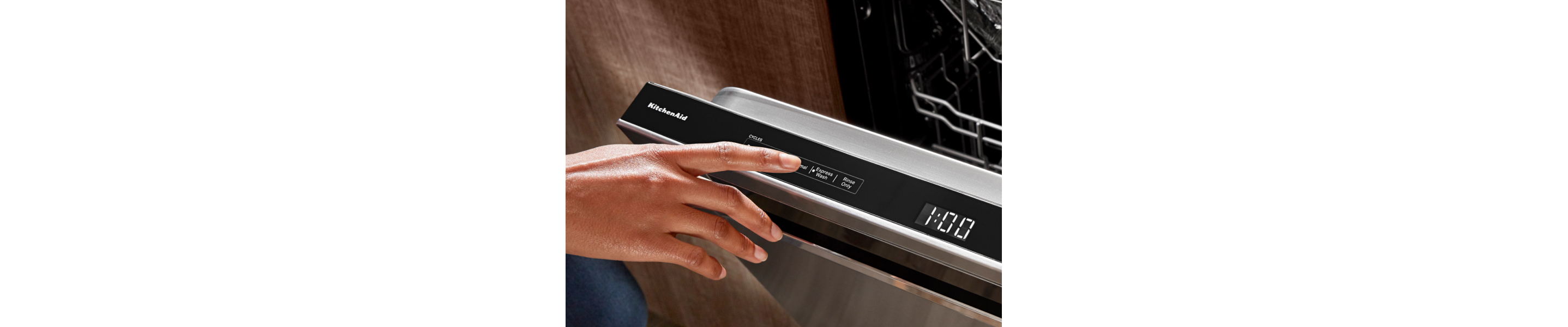 Person selecting a wash cycle on a top control dishwasher