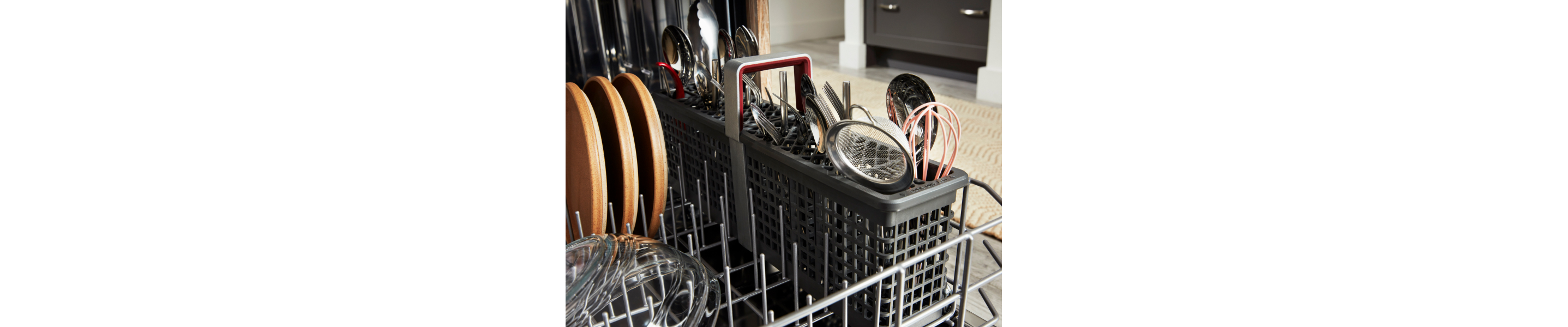 Open dishwasher filled with dishes and utensils