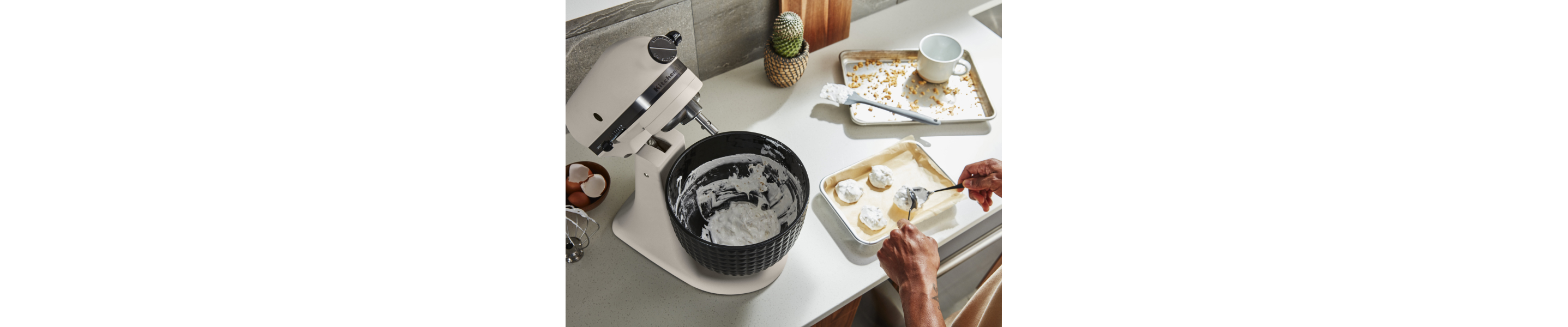 Person putting dough onto prepared baking dish