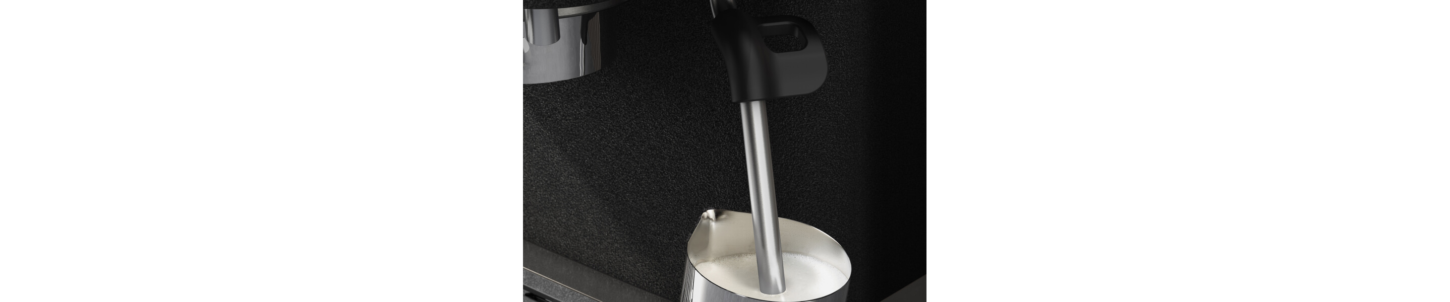 Espresso machine steam wand inside a milk carafe