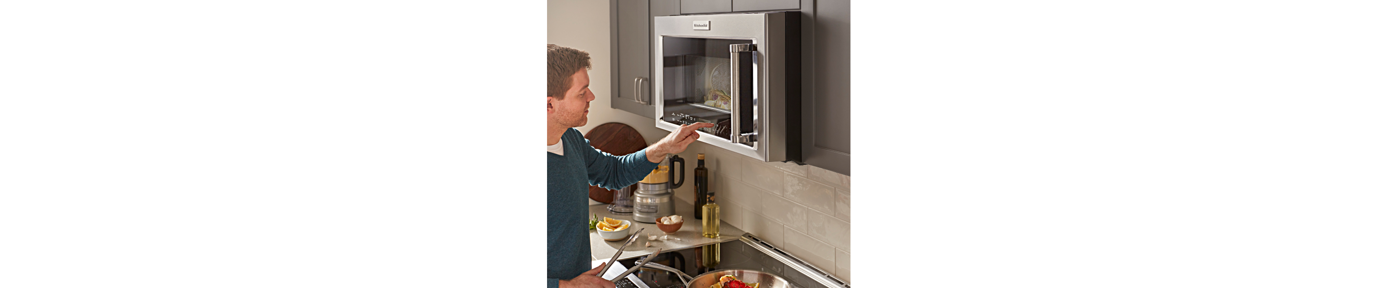 Man using an over-the-range microwave 