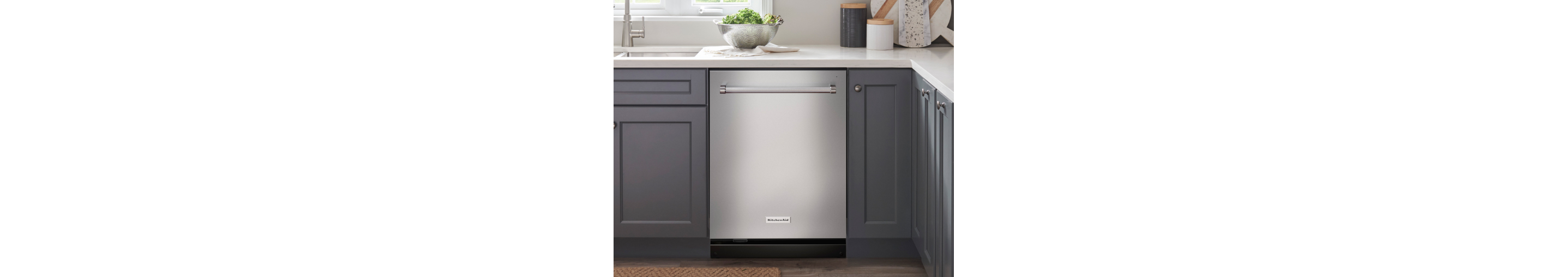 Stainless steel KitchenAid® dishwasher in blue kitchen