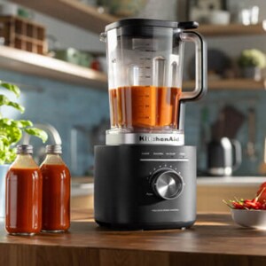 Blender next to bottles of juice