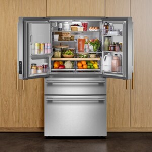 Open French door refrigerator filled with groceries