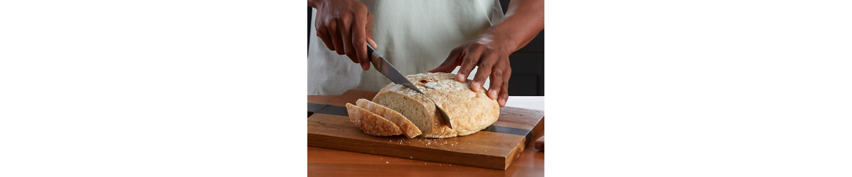 Person slicing bread