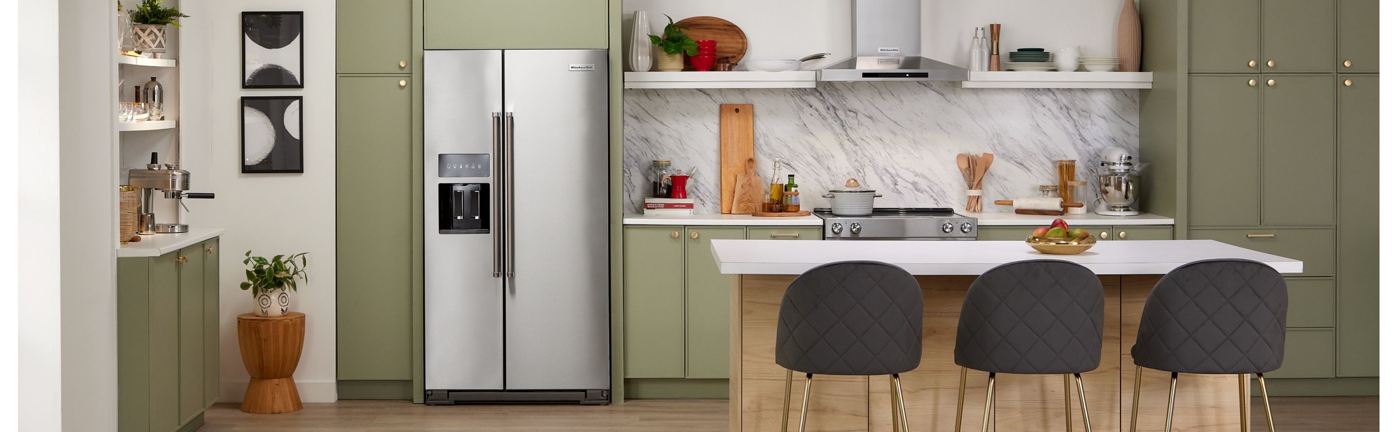 KitchenAid® side-by-side refrigerator built into green cabinetry