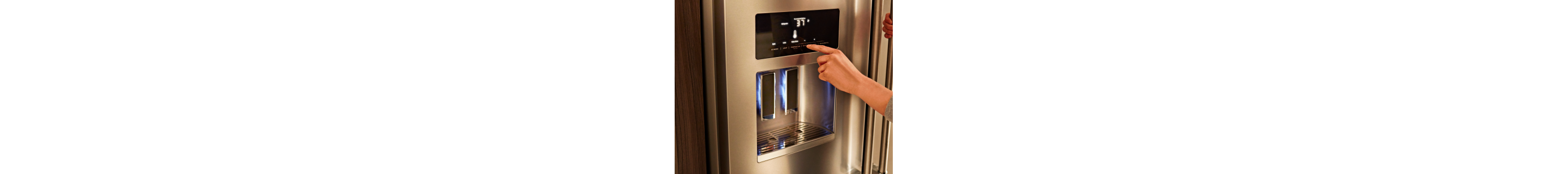 Person adjusting temperature settings on a refrigerator display 