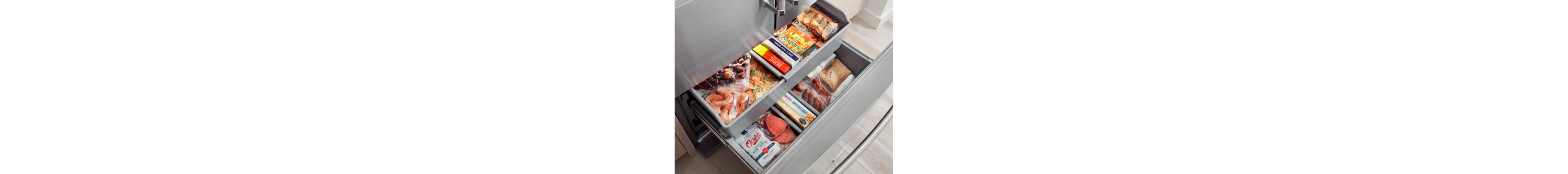 Open bottom freezer drawer full of food