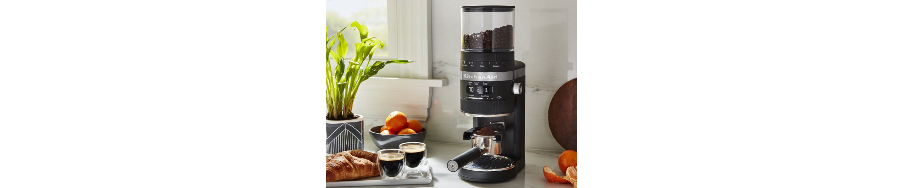KitchenAid® Burr Coffee Grinder filled with coffee beans on counter