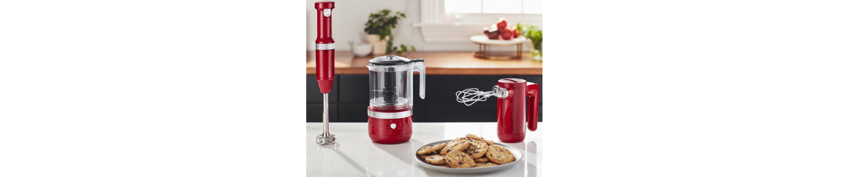 Red cordless KitchenAid® hand blender, food chopper and hand mixer on counter