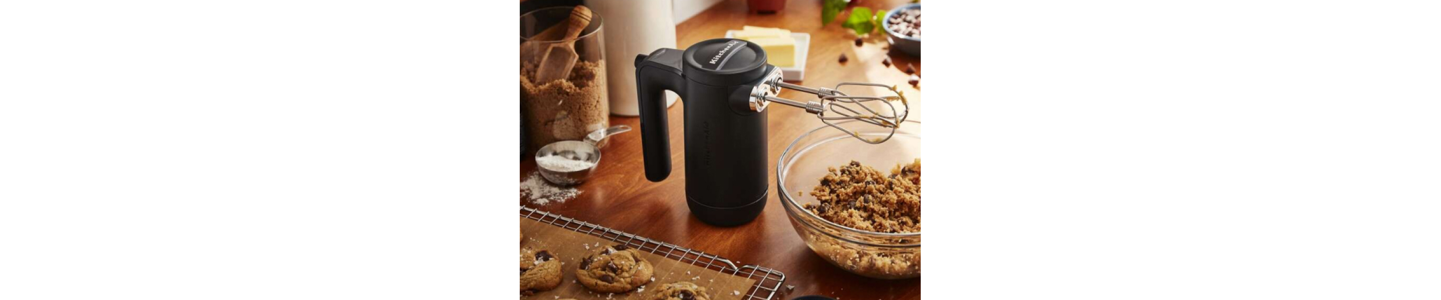 Matte black KitchenAid® hand mixer near bowl of cookie dough
