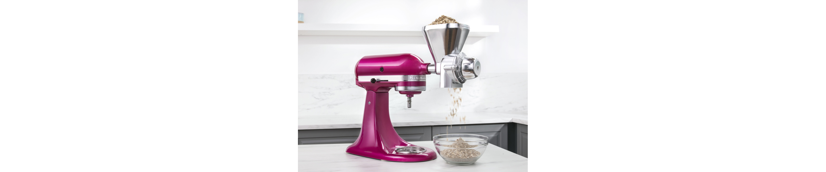 Pink KitchenAid® stand mixer with the All Metal Grain Mill Attachment grinding food