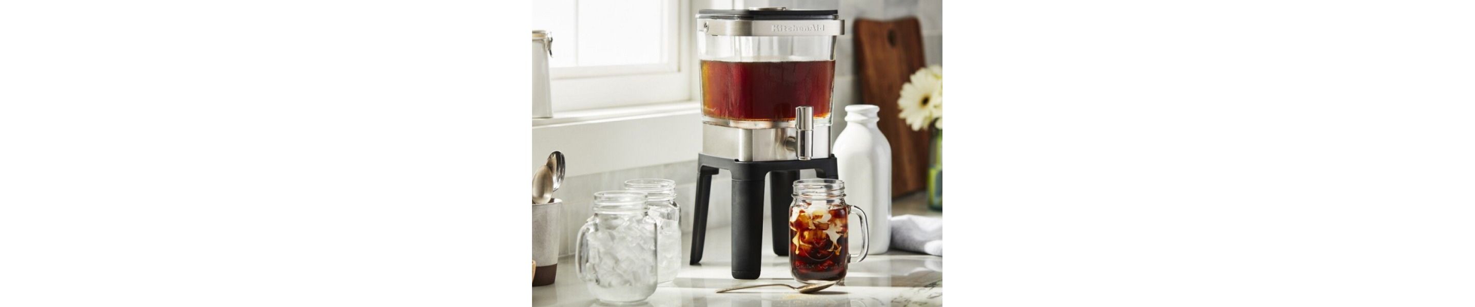 KitchenAid® cold brew coffee maker above mason jar glass filled with coffee