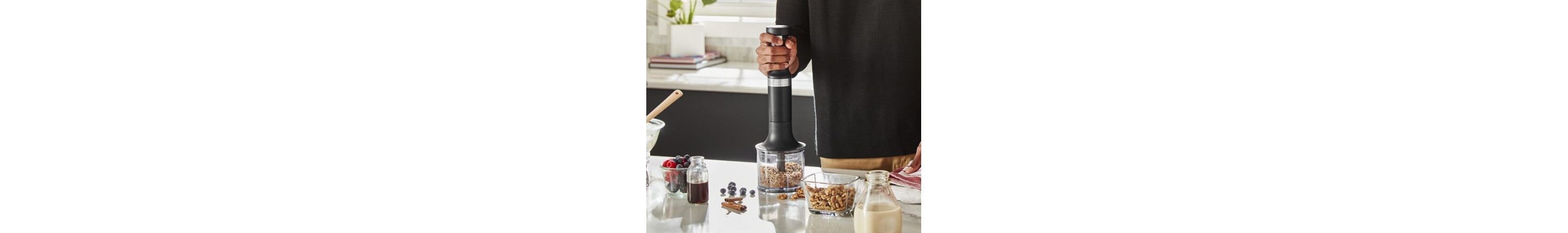 Man chopping nuts with hand blender chopper attachment