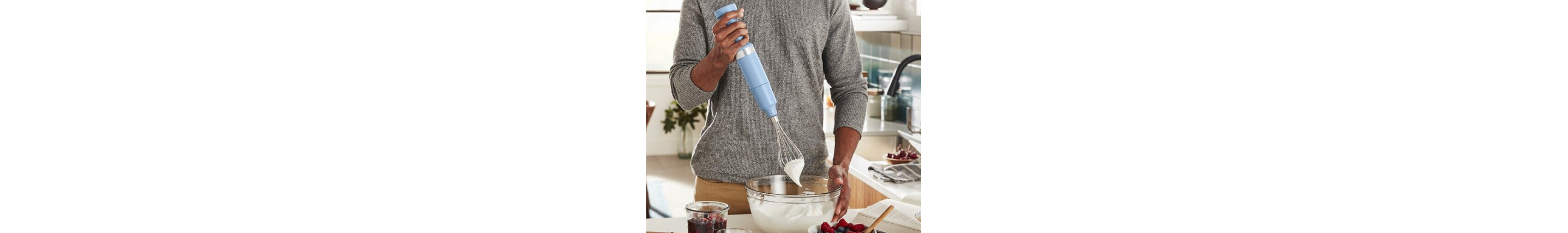  Man whipping cream with immersion blender