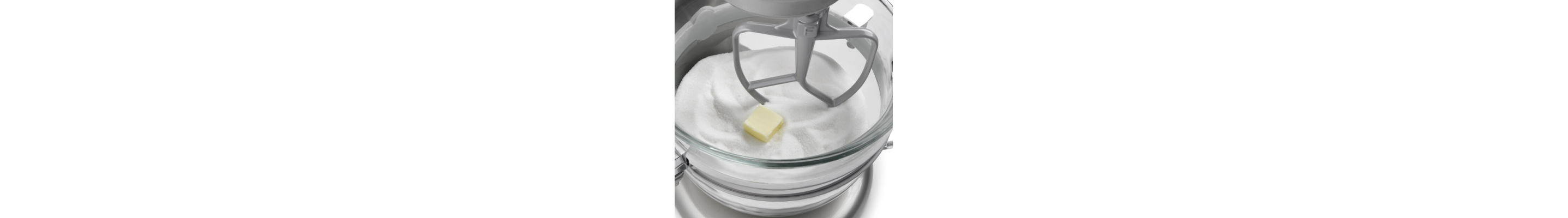 A stand mixer with butter and sugar