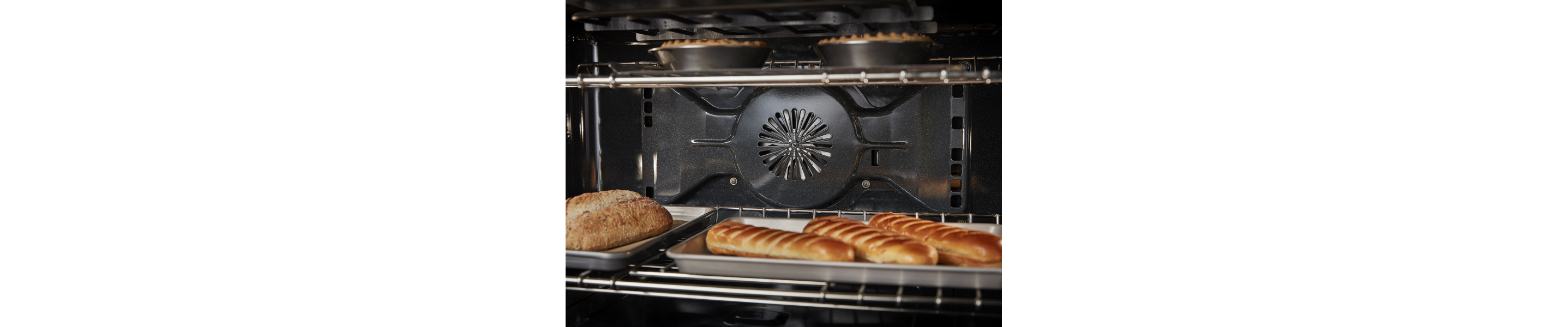 Bread and pies baking on multiple racks in convection oven