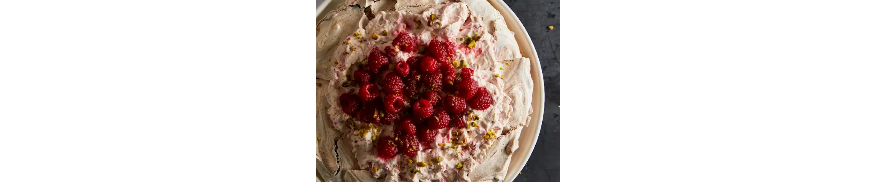 Pavlova with raspberries and raspberry whipped cream